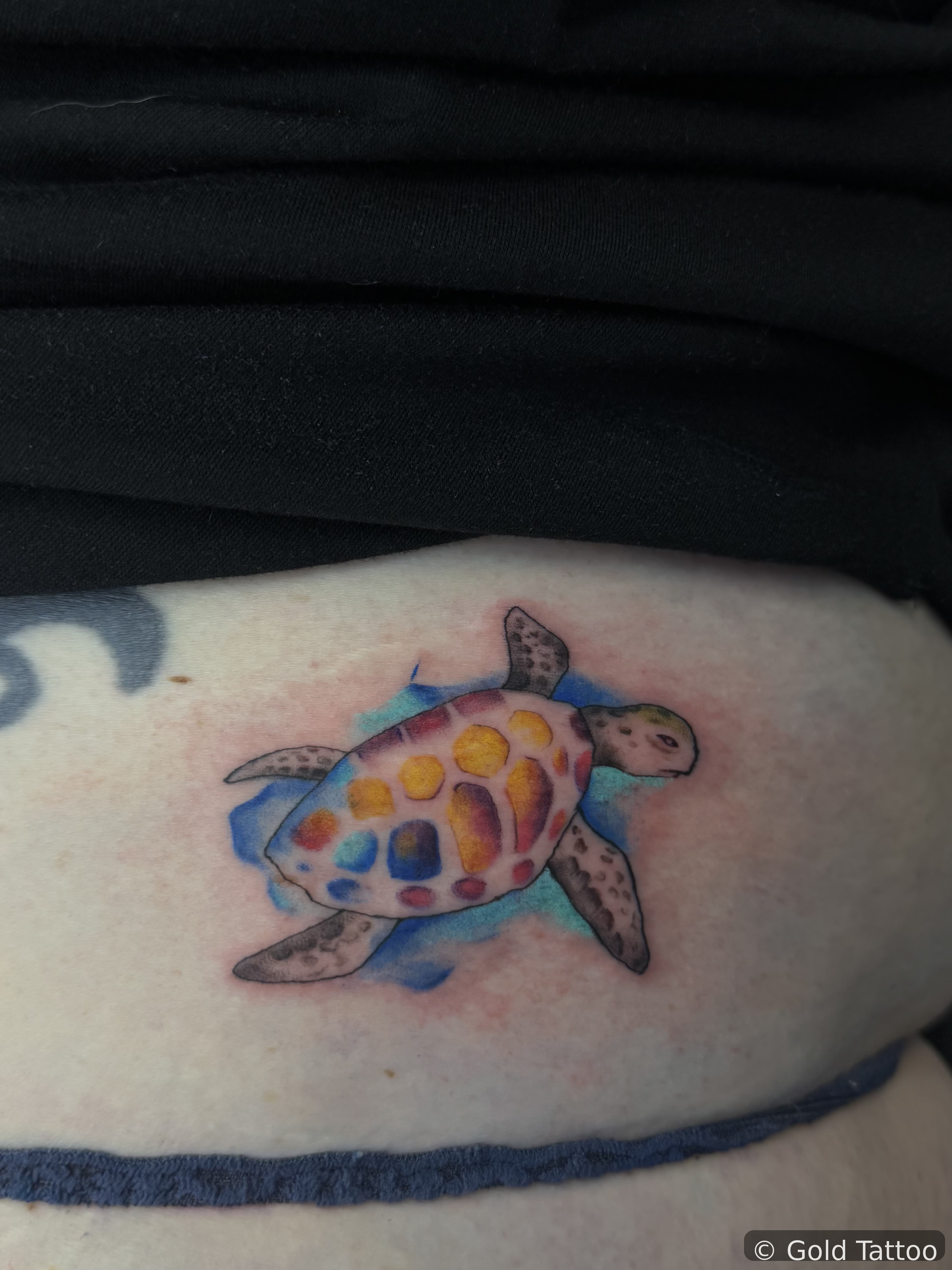 Watercolor sea turtle tattoo on a side by Gia “DOC” at Gold Tattoo, 1506 S Las Vegas Blvd, Unit 3