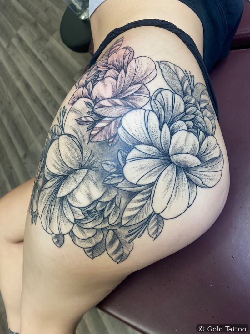 Black and grey peony flower piece on a hip by Nathan at Gold Tattoo, 1506 S Las Vegas Blvd, Unit 3