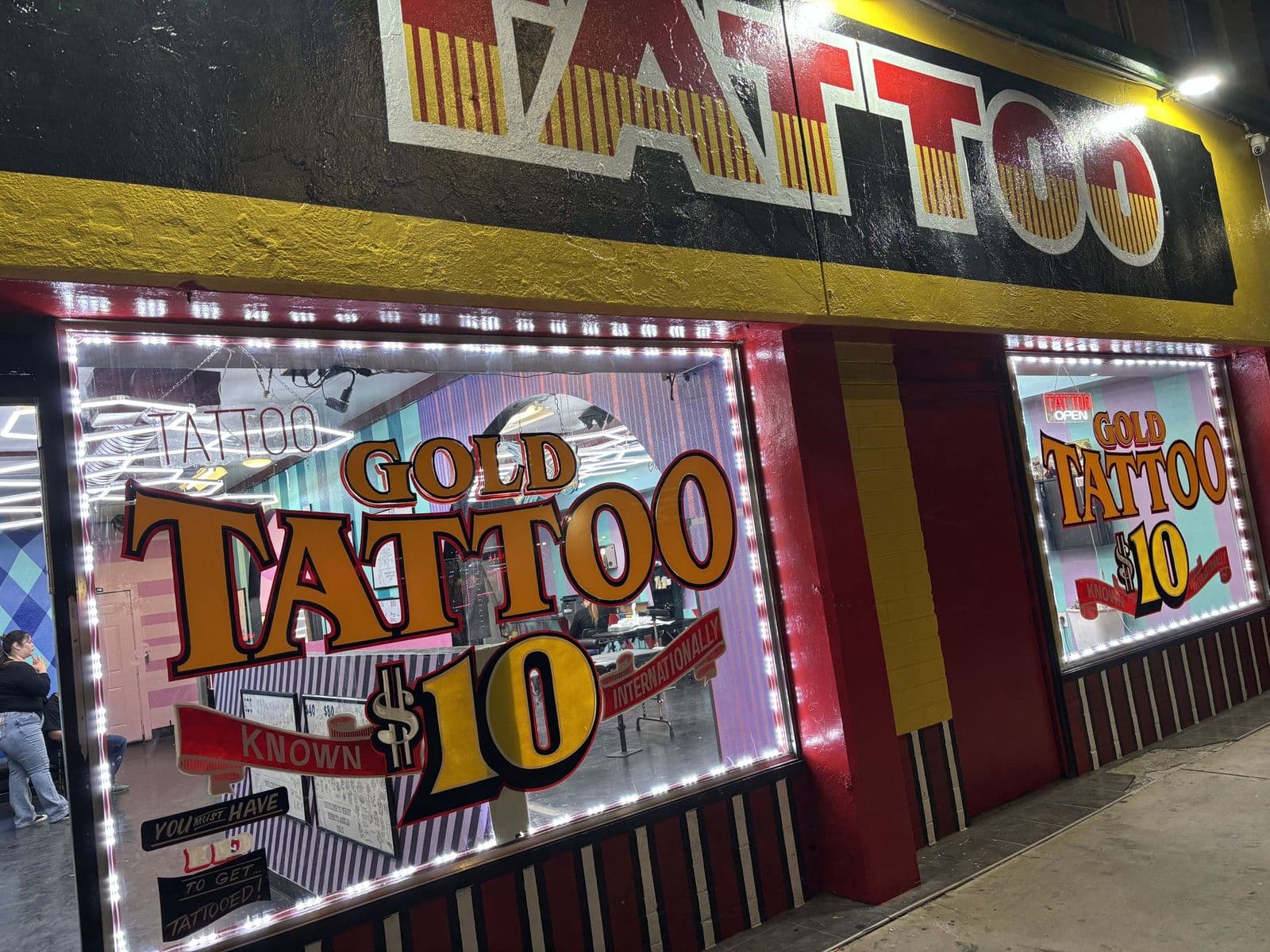 Lit front windows of Gold Tattoo at 1506 S Las Vegas Blvd, Unit 3 at night